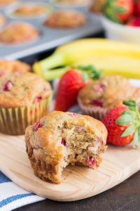 a strawberry banana muffin with a bite taken out of it.