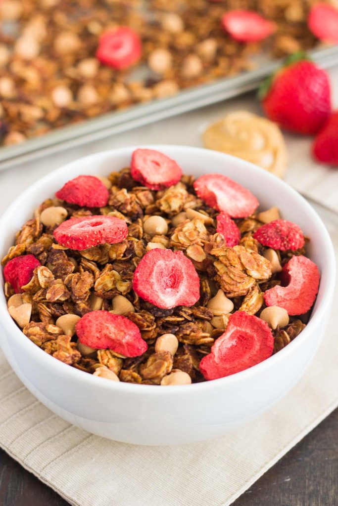 This Strawberry Peanut Butter Granola is packed with crunchy granola clusters, pecans, peanut butter chips, and strawberries. It's an easy treat that makes the perfect breakfast or snack to satisfy your peanut butter cravings!