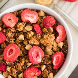 This Strawberry Peanut Butter Granola is packed with crunchy granola clusters, pecans, peanut butter chips, and strawberries. It's an easy treat that makes the perfect breakfast or snack to satisfy your peanut butter cravings!