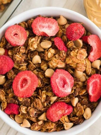 This Strawberry Peanut Butter Granola is packed with crunchy granola clusters, pecans, peanut butter chips, and strawberries. It's an easy treat that makes the perfect breakfast or snack to satisfy your peanut butter cravings!