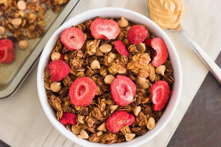This Strawberry Peanut Butter Granola is packed with crunchy granola clusters, pecans, peanut butter chips, and strawberries. It's an easy treat that makes the perfect breakfast or snack to satisfy your peanut butter cravings!