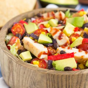 This Barbecue Ranch Chicken Salad is packed with fresh greens, tender chicken, black beans, corn, tomatoes, red onion, and avocado. It's tossed with a creamy barbecue ranch dressing and is full of flavor. Better than the restaurant version and so easy to make, you'll love the fresh ingredients in this easy summer salad!