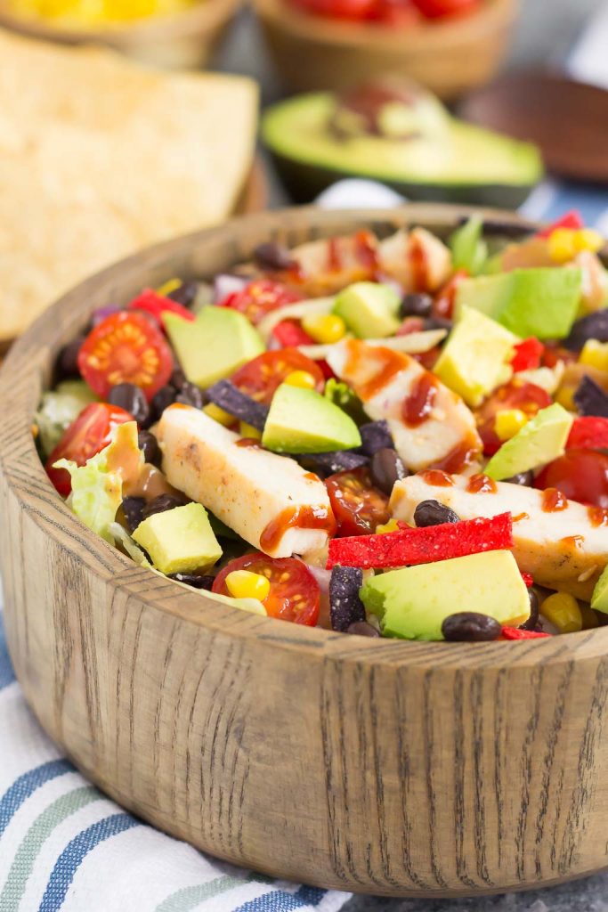 This Barbecue Ranch Chicken Salad is packed with fresh greens, tender chicken, black beans, corn, tomatoes, red onion, and avocado. It's tossed with a creamy barbecue ranch dressing and is full of flavor. Better than the restaurant version and so easy to make, you'll love the fresh ingredients in this easy summer salad!