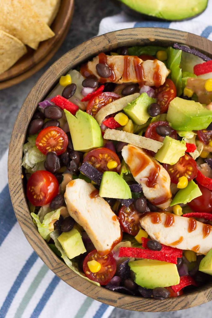 This Barbecue Ranch Chicken Salad is packed with fresh greens, tender chicken, black beans, corn, tomatoes, red onion, and avocado. It's tossed with a creamy barbecue ranch dressing and is full of flavor. Better than the restaurant version and so easy to make, you'll love the fresh ingredients in this easy summer salad!