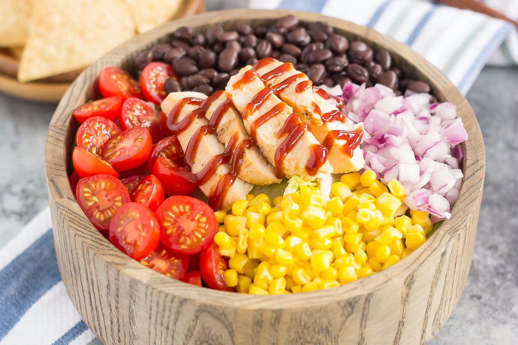 This Barbecue Ranch Chicken Salad is packed with fresh greens, tender chicken, black beans, corn, tomatoes, red onion, and avocado. It's tossed with a creamy barbecue ranch dressing and is full of flavor. Better than the restaurant version and so easy to make, you'll love the fresh ingredients in this easy summer salad!