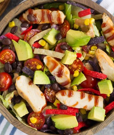 This Barbecue Ranch Chicken Salad is packed with fresh greens, tender chicken, black beans, corn, tomatoes, red onion, and avocado. It's tossed with a creamy barbecue ranch dressing and is full of flavor. Better than the restaurant version and so easy to make, you'll love the fresh ingredients in this easy summer salad!