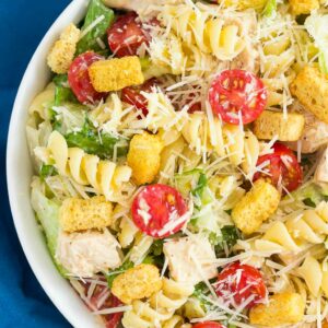 This Chicken Caesar Pasta Salad is a simple dish that's ready in less than 30 minutes. Romaine lettuce, fresh pasta, chicken, and Parmesan cheese are tossed in a creamy caesar dressing that's full of flavor. Light, yet filling, this easy dish makes a delicious weeknight meal!