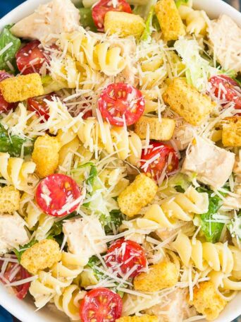 This Chicken Caesar Pasta Salad is a simple dish that's ready in less than 30 minutes. Romaine lettuce, fresh pasta, chicken, and Parmesan cheese are tossed in a creamy caesar dressing that's full of flavor. Light, yet filling, this easy dish makes a delicious weeknight meal!