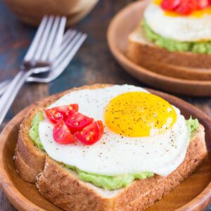 This Fried Egg and Avocado Toast is a deliciously simple way to jazz up your breakfast or snack. Hearty bread is toasted and then topped with mashed avocado, a fried egg, and cherry tomatoes. It’s ready in just minutes and is full of healthy ingredients!