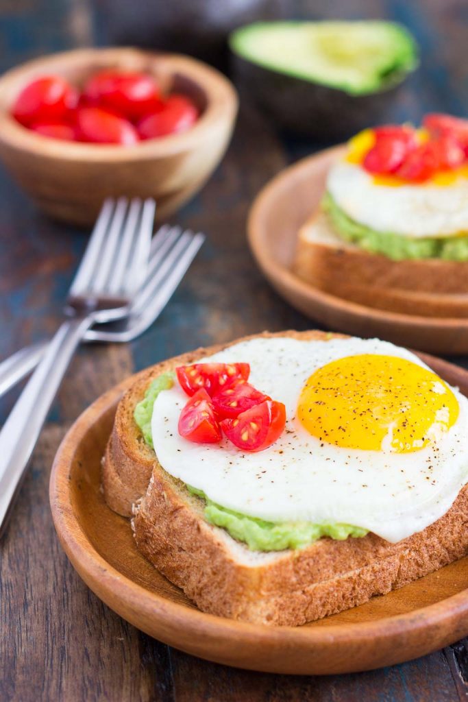 This Fried Egg and Avocado Toast is a deliciously simple way to jazz up your breakfast or snack. Hearty bread is toasted and then topped with mashed avocado, a fried egg, and cherry tomatoes. It’s ready in just minutes and is full of healthy ingredients!