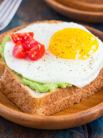 This Fried Egg and Avocado Toast is a deliciously simple way to jazz up your breakfast or snack. Hearty bread is toasted and then topped with mashed avocado, a fried egg, and cherry tomatoes. It’s ready in just minutes and is full of healthy ingredients!