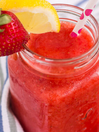This Frozen Strawberry Lemonade is refreshing blend of sweet strawberries and fresh lemonade. The sweet and tangy flavor is blended to perfection, which results in a cool treat that's made for those hot, summer days!
