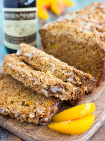 This Glazed Peach Streusel Bread is packed with juicy peaches and topped with a cinnamon crumble and sweet vanilla glaze. You'll fall in love with the soft and fluffy texture and deliciously sweet flavor!