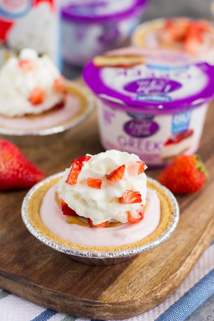 These Mini Strawberry Peanut Butter Cheesecake Pies are filled with Dannon® Light & Fit® Strawberry Cheesecake Greek Yogurt, creamy peanut butter, and fresh strawberries. Easy to make and packed with flavor, you can enjoy this no-bake, simple dessert that's perfect for the warmer weather!
