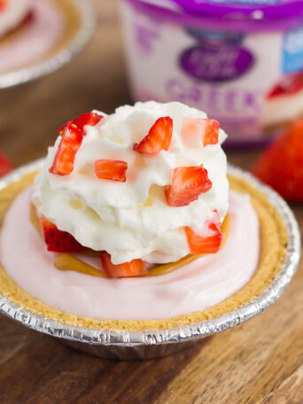 These Mini Strawberry Peanut Butter Cheesecake Pies are filled with Dannon® Light & Fit® Strawberry Cheesecake Greek Yogurt, creamy peanut butter, and fresh strawberries. Easy to make and packed with flavor, you can enjoy this no-bake, simple dessert that's perfect for the warmer weather!