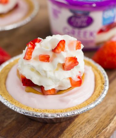 These Mini Strawberry Peanut Butter Cheesecake Pies are filled with Dannon® Light & Fit® Strawberry Cheesecake Greek Yogurt, creamy peanut butter, and fresh strawberries. Easy to make and packed with flavor, you can enjoy this no-bake, simple dessert that's perfect for the warmer weather!