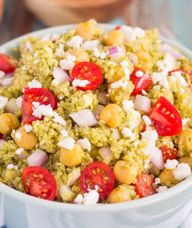 This Quinoa and Chickpea Pesto Salad is filled with chickpeas, hearty quinoa, cherry tomatoes, red onions, and crumbled feta cheese. It's tossed with a zesty pesto sauce that packs a punch of flavor in every bite. It's easy to prepare and makes simple dish that's perfect for lunch or dinner!