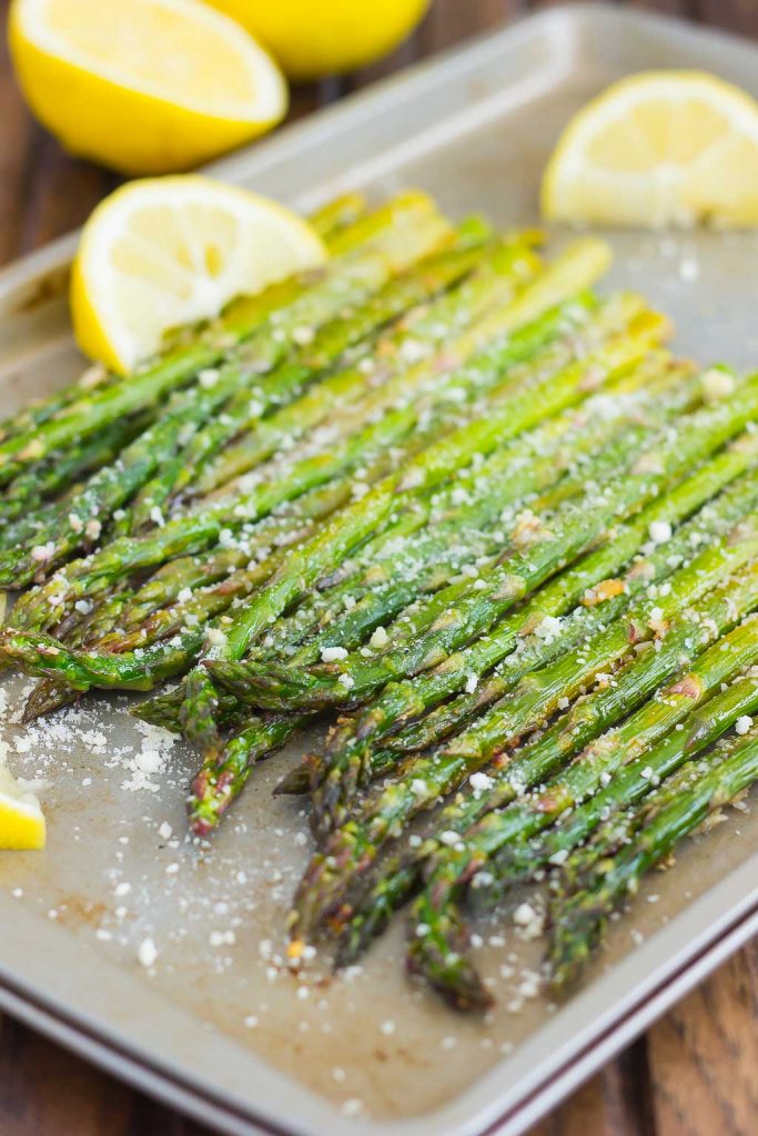 angled shot of roasted lemon asparagus in a pan