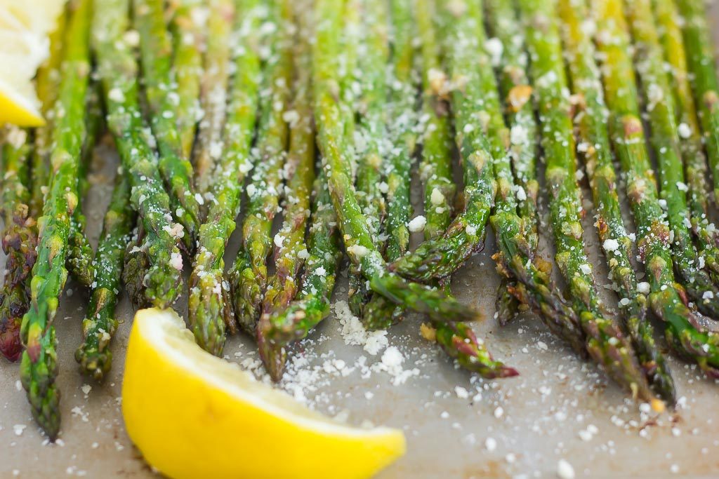 parmesan asparagus in a pan with lemon