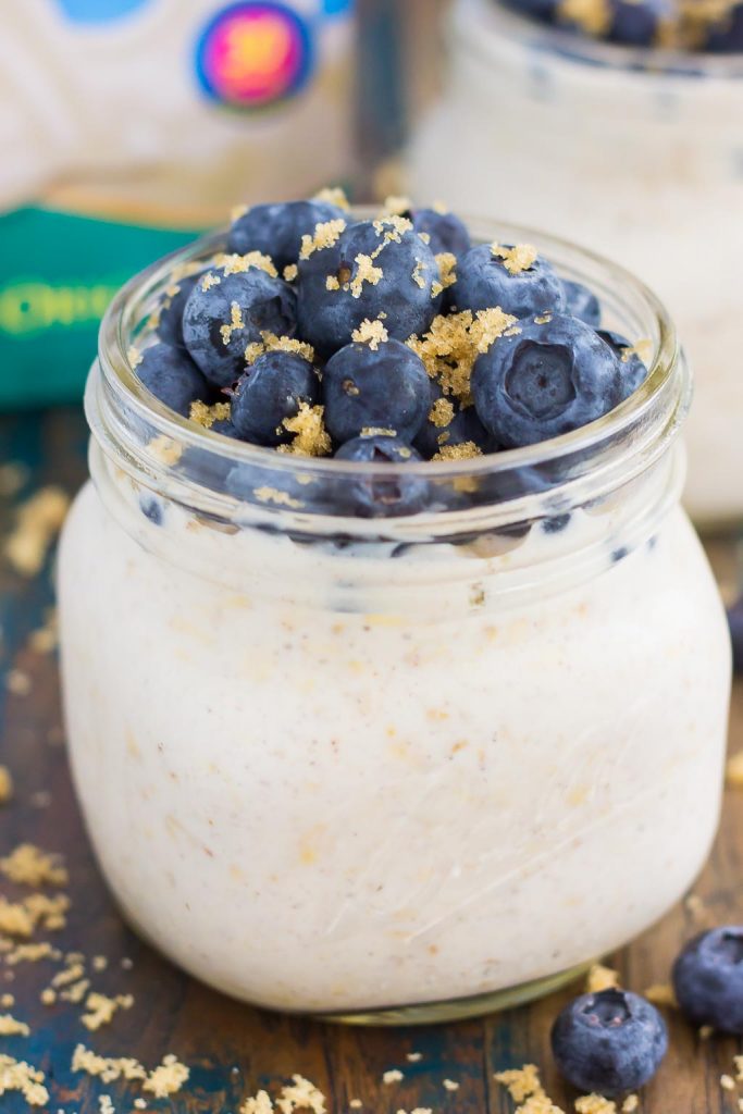 A jar of overnight oats with blueberries on top. 