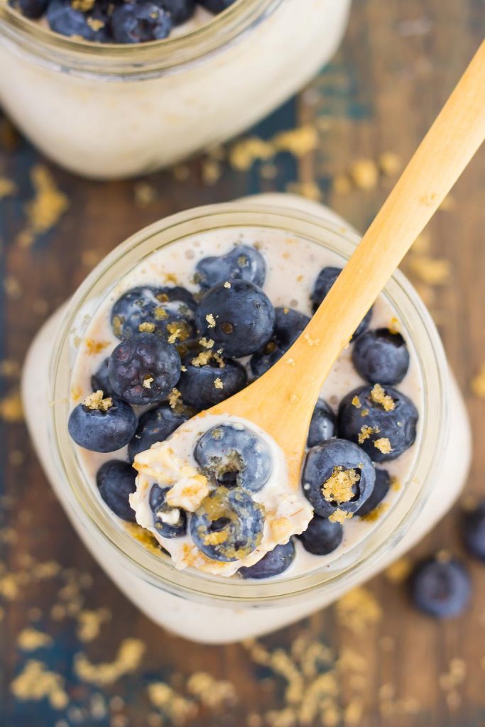 Overhead view of a jar of overnight oats with blueberries on top. 