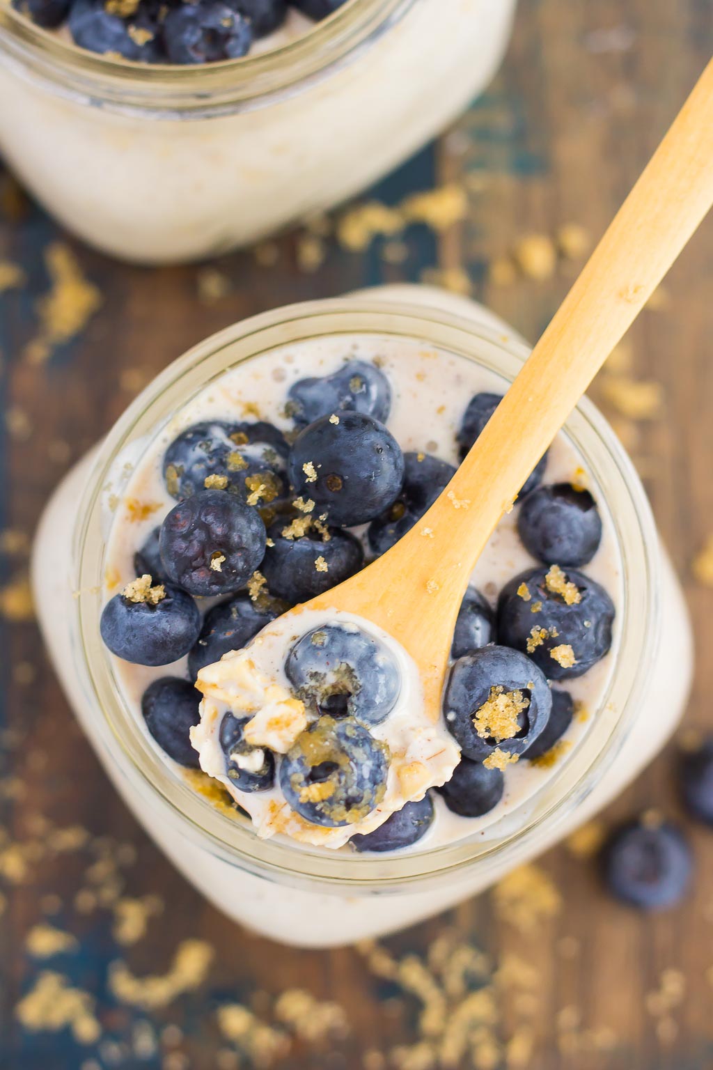 Overhead view of a jar of overnight oats with blueberries on top.