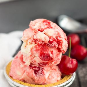 This easy, five ingredient Cherry Cheesecake Ice Cream is cool, creamy and packed with flavor. This no-churn treat features a vanilla cheesecake base that's loaded with juicy cherries. And best of all, it's made without an ice cream maker!