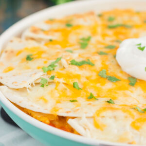 This One Pan Chicken Enchilada Bake is loaded with shredded chicken, hearty rice, and topped with cheesy tortillas. It contains the classic flavor of enchiladas, but in casserole form. Made in one pan and ready in just 30 minutes, you'll have this simple dish ready to be devoured in no time!