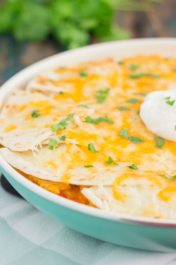 This One Pan Chicken Enchilada Bake is loaded with shredded chicken, hearty rice, and topped with cheesy tortillas. It contains the classic flavor of enchiladas, but in casserole form. Made in one pan and ready in just 30 minutes, you'll have this simple dish ready to be devoured in no time!