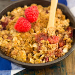 This Raspberry Rhubarb Crisp is filled with sweet raspberries, fresh rhubarb, and sprinkled with a brown sugar oat crumble. It's prepared in just minutes and makes an easy dessert that's perfect to enjoy all year long!