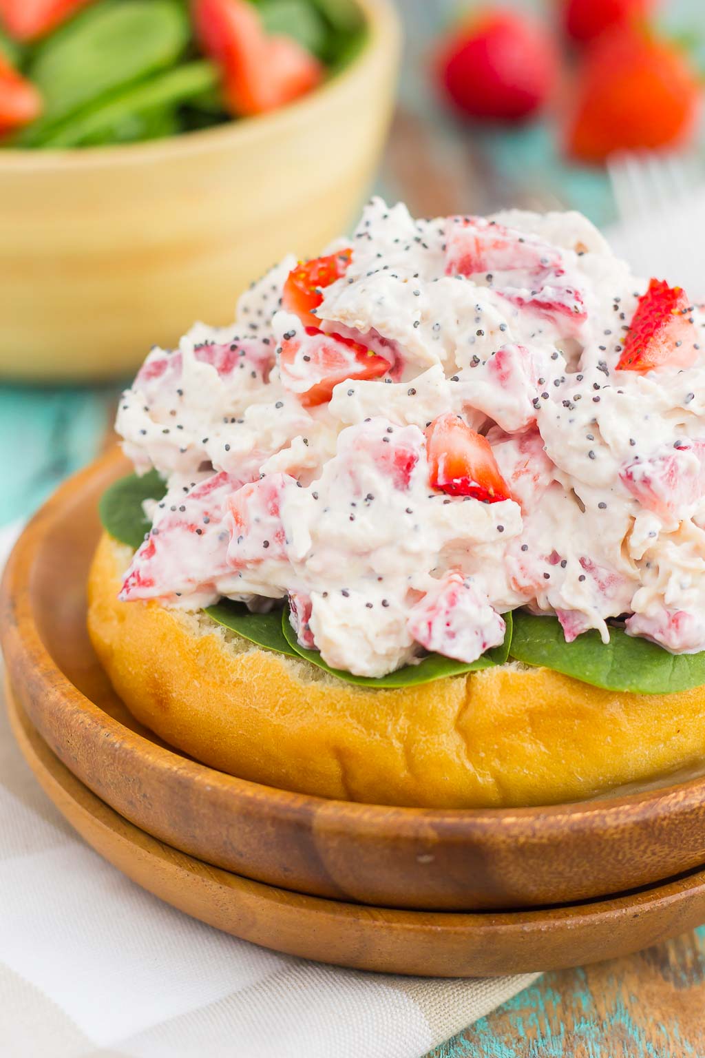 This Strawberry Poppy Seed Chicken Salad is packed with shredded chicken, a light dressing of Greek yogurt and mayo, and bursting with juicy strawberries and poppy seeds. This dish is fresh, flavorful, and filled with just the right amount of sweetness! #strawberrychicken #strawberrychickensalad #strawberrypoppyseed #poppyseedchickensalad #chickensalad #chicken #healthylunch #healthysalad #summersalad