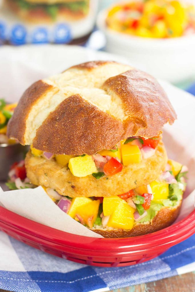 These Alaskan Pollock Burgers with Peach Mango Salsa are easy to prepare and bursting with flavor. The Alaskan Pollock patty provides a mild taste, while the peach mango salsa gives it the perfect touch of sweet and spicy! #burger #pollock #pollockburger #peachsalsa #mangosalsa #summerburger #easyburger #dinner