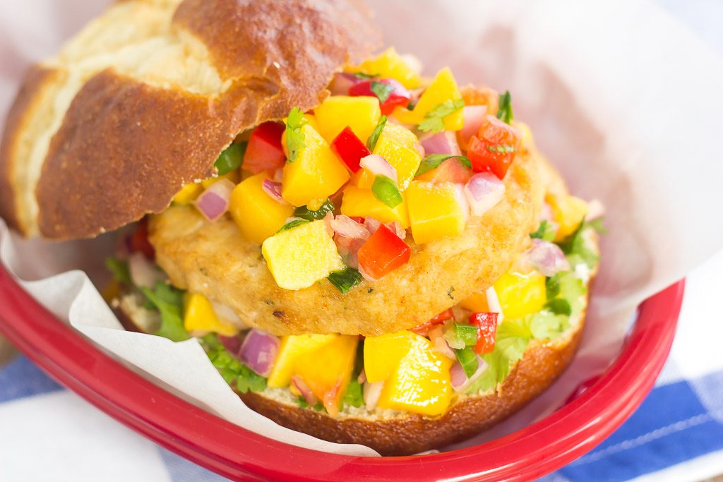 These Alaskan Pollock Burgers with Peach Mango Salsa are easy to prepare and bursting with flavor. The Alaskan Pollock patty provides a mild taste, while the peach mango salsa gives it the perfect touch of sweet and spicy. If you're looking for a new burger filed with the tastes of summer, then this is it!