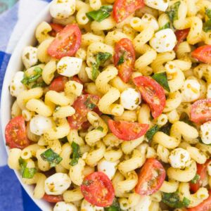 This Caprese Pasta Salad is filled with tender noodles, cherry tomatoes, fresh basil, and creamy mozzarella cheese. It's tossed in a white balsamic and pesto dressing, which gives this dish a burst of flavor. Simple, fresh, and full of flavor, this pasta salad is ready in minutes and is perfect for summer!