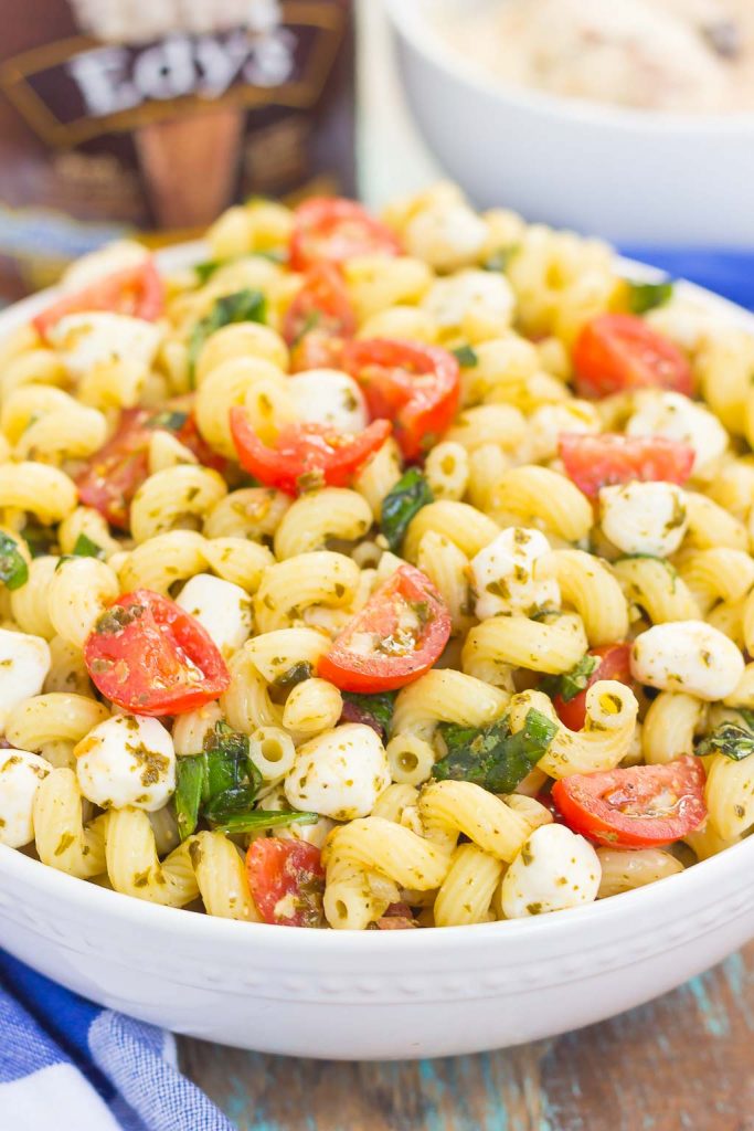 large white bowl of caprese pasta salad