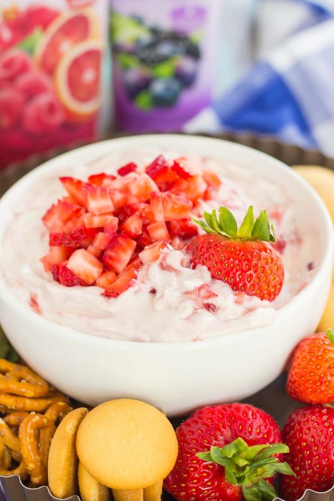 A bowl of strawberry cheesecake dip, surrounded by various dippers. 