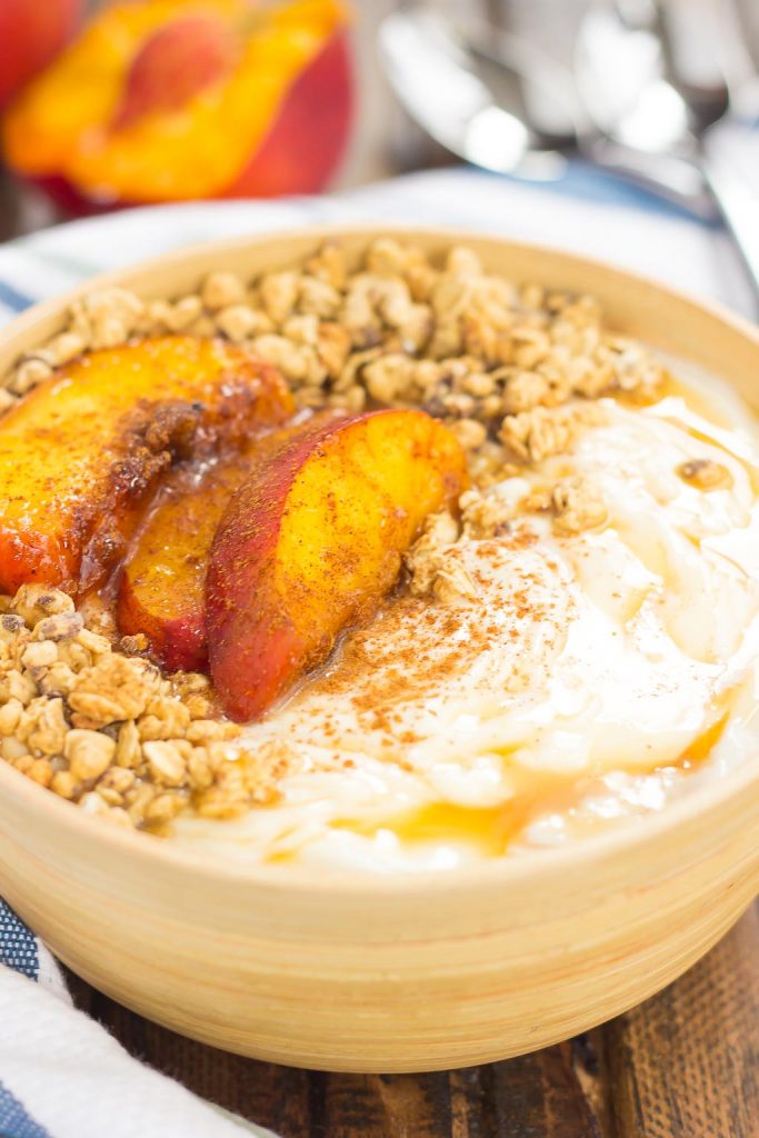 This Grilled Peach Caramel Yogurt Bowl is filled with creamy, vanilla Greek yogurt, grilled peaches with cinnamon and brown sugar, a sweet caramel sauce, and crunchy granola. It's ready in minutes and makes the perfect breakfast or snack! #yogurt #yogurtbowl #yogurtbowlrecipe #grilledpeaches #peachyogurtbowl #healthybreakfast #healthysnack #breakfast