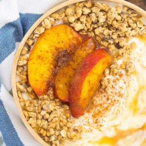 This Grilled Peach Caramel Yogurt Bowl is filled with creamy, vanilla Greek yogurt, grilled peaches with cinnamon and brown sugar, a sweet caramel sauce, and crunchy granola. It's ready in minutes and makes the perfect breakfast or snack!
