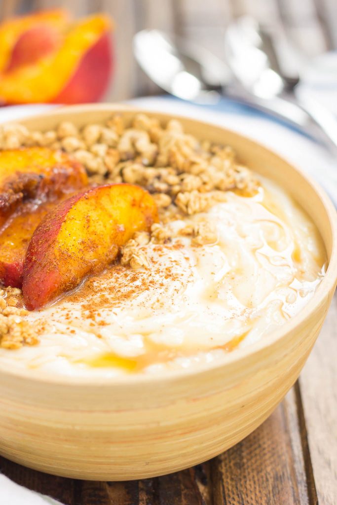 This Grilled Peach Caramel Yogurt Bowl is filled with creamy, vanilla Greek yogurt, grilled peaches with cinnamon and brown sugar, a sweet caramel sauce, and crunchy granola. It's ready in minutes and makes the perfect breakfast or snack!