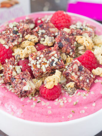 This Raspberry Almond Butter Smoothie Bowl is a delicious way to start your mornings off right. Packed with sweet raspberries, Greek yogurt, and almond butter, this bowl is bursting with flavor and just the right amount nutritious ingredients. Top this dish with a Curate Bar, granola, fruit, and more for a healthy breakfast or mid-morning snack!