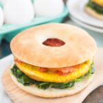 This Spinach, Bacon and Feta Breakfast Sandwich is an easy, make-ahead dish that's full of fresh ingredients. Fluffy eggs are seasoned with creamy feta cheese, and then topped sautéed spinach and smoky bacon. This sandwich makes a delicious and hearty breakfast for those busy weekday mornings!