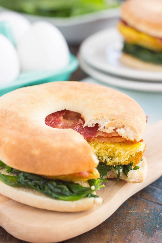 This Spinach, Bacon and Feta Breakfast Sandwich is an easy, make-ahead dish that's full of fresh ingredients. Fluffy eggs are seasoned with creamy feta cheese, and then topped sautéed spinach and smoky bacon. This sandwich makes a delicious and hearty breakfast for those busy weekday mornings!