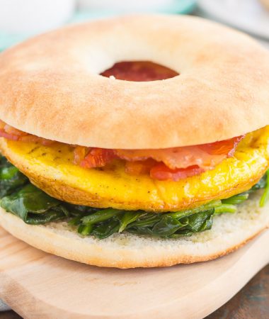 This Spinach, Bacon and Feta Breakfast Sandwich is an easy, make-ahead dish that's full of fresh ingredients. Fluffy eggs are seasoned with creamy feta cheese, and then topped sautéed spinach and smoky bacon. This sandwich makes a delicious and hearty breakfast for those busy weekday mornings!