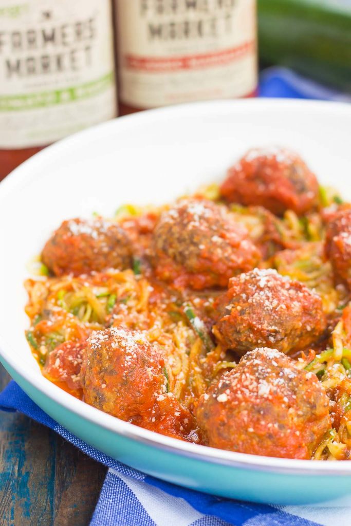 A skillet of zucchini noodles and meatballs. 