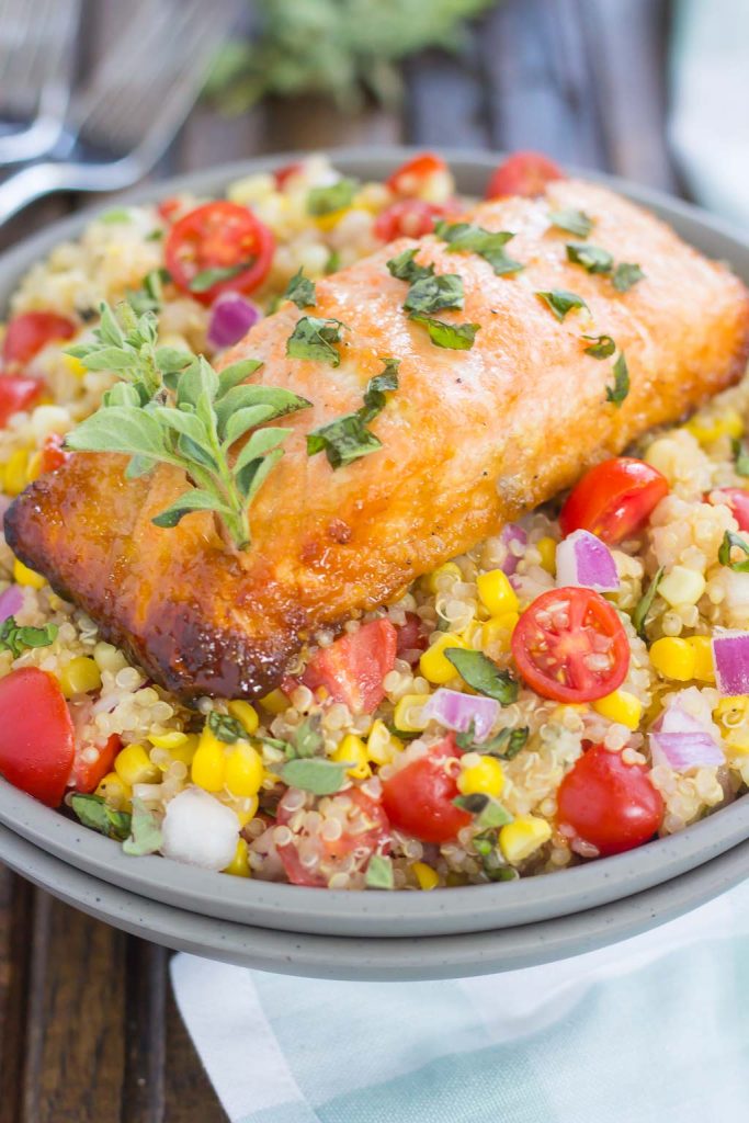 a salmon power bowl topped with fresh herbs