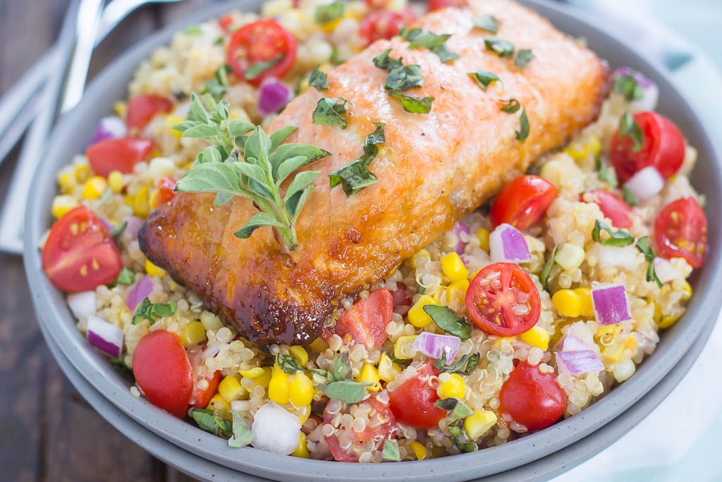 a salmon bowl topped with fresh herbs