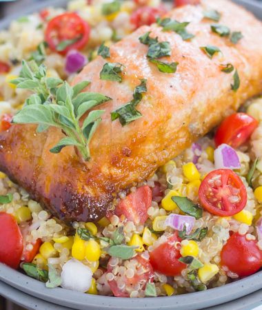 This Honey Garlic Salmon Quinoa Bowl is a flavorful and delicious, protein-packed meal. It's filled with hearty quinoa, fresh corn, cherry tomatoes, and herbs. Tossed in a simple, white balsamic dressing and served with salmon seasoned with a honey garlic sauce, this easy dish is ready in just 30 minutes and full of flavor!