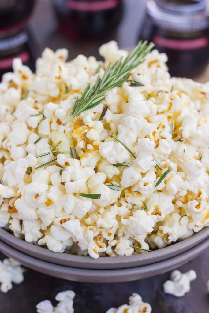 This Rosemary Garlic Popcorn is drizzled with a buttery mix filled with fresh rosemary and a hint of garlic. Simple, easy, and perfect for on-the-go entertaining, this crunchy snack is sure to be the hit of any party! 