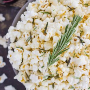 This Rosemary Garlic Popcorn is drizzled with a buttery mix filled with fresh rosemary and a hint of garlic. Simple, easy, and perfect for on-the-go entertaining, this crunchy snack is sure to be the hit of any party!