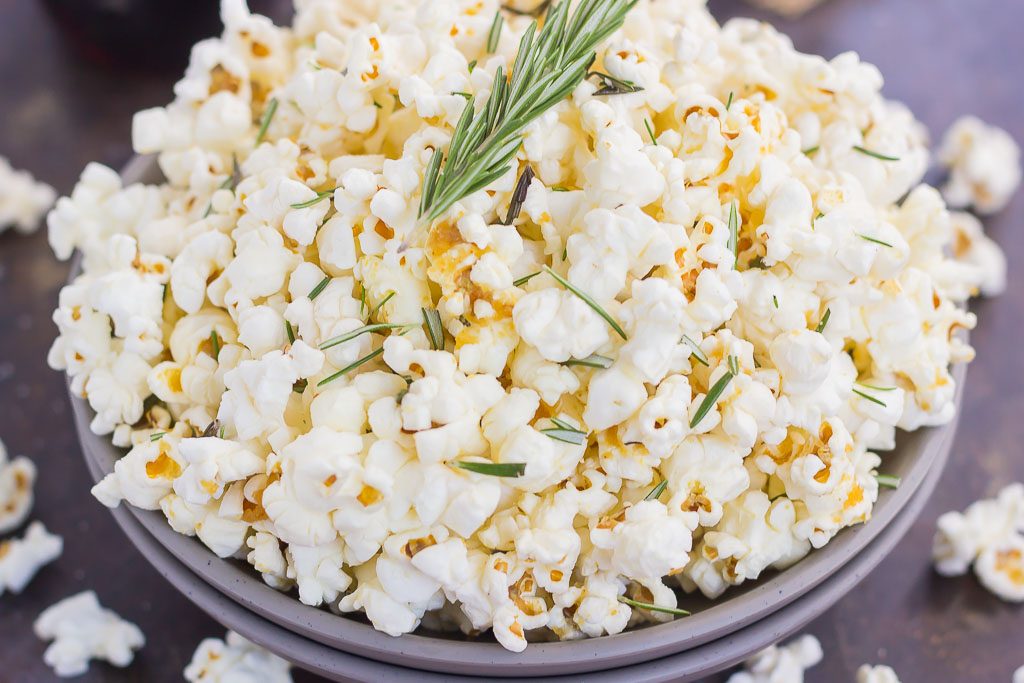 This Rosemary Garlic Popcorn is drizzled with a buttery mix filled with fresh rosemary and a hint of garlic. Simple, easy, and perfect for on-the-go entertaining, this crunchy snack is sure to be the hit of any party! 